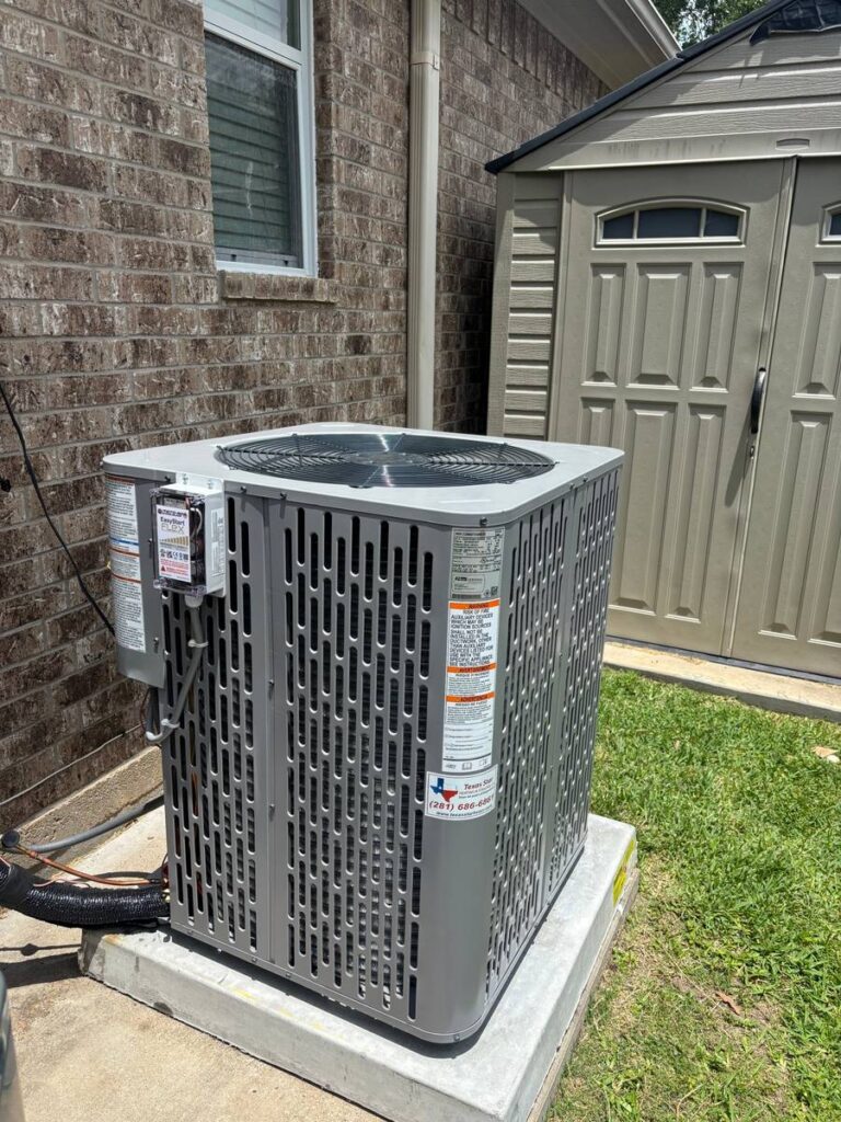 New AC condenser replacement on a concrete pad at a Cypress, TX home by Texas Star Heating & Cooling